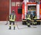 three firefighters in action and the fire engine with hose