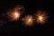 Three fireworks on a black background