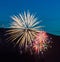 Three fireworks over blue sky background