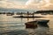 Three fishermen Tres pescadores sculpture and fishermen boats at Buzios beach, Brazil during dusk on a cloudy summer day