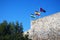 Three flags: Spain, Andolusia and Malaga on the defensive wall of the fortress. Arab fortress Gibralfaro Spanish. Castillo de Jib