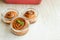 Three flavored freshly baked cinnamon rolls or cinnabons with mint leaf into glass baking dishes