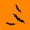 three flying bats in silhouette, black design elements on orange background, halloween window decoration, vector