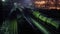 Three freight trains move on railway at winter night