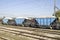 Three freight wagons with gravel on the siding