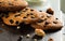 Three fresh baked cookies with raisin and chocolate on the pan