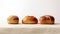 Three fresh breads on a white tablecloth against a white background