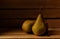 Three fresh picked Bosc Pears in a wooden packing crate