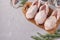 Three fresh raw organic quails on wooden board on a gray background, Copy space, Top view