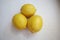 Three fresh yellow color lemons white background