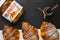 Three freshly baked croissant with nutella or jam on a black background. Traditional french or italian breakfast