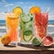 Three freshly squeezed juices on a table on the beach 2