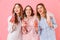 Three friendly women with good mood in colorful striped pyjamas