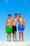 Three friends in bathing trunks stick together