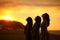Three friends breathing fresh air at sunset