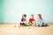 Three friends building with blocks on a floor