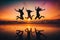 Three friends having fun at the beach. Silhouettes jumping at sunset. Spring break concept.