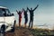 Three friends joined hands and raised their hands up, enjoying the view of Outdoor.Vacations Journey Concept