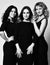 Three friends stylish young women in black tight midi dresses are are going to the dinner party. Black and white