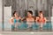 Three friends in swimming pool or thermal bath