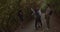 Three friends waiting for their female friend while standing on a train in the mountain. She arrives as they warmly