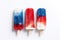 Three fruit colorful popsicles in blue, red and white colors.