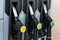 Three fueling pistols at a gas station for cars. Close-up