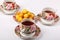 Three full porcelain teacups with tea and with floral pattern and plate with wild apricots