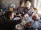 Three funny children in the kitchen help their mother peel garlic. Boys brothers are happy to do useful things together