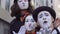 Three funny mimes have fun in front of camera