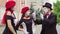 Three funny mimes play scenes in the city street