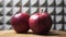 Three gala apples on a rotating wooden table, close-up video. Red apples side view. Fruits on a gray background