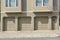 Three garage doors of a house with light gray exterior at San Francisco, California