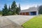 Three garages with blue and brick trim.