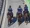 Three gendarmes on horseback in the street in France