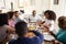 Three generation African American  family sitting at dinner table eating together, elevated view