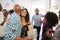 Three generation African American  family welcoming guests in the doorway of their home,close up