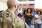 Three generation African American  family welcoming soldier returning home,over shoulder view, close up