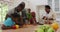 Three generation african american family working together in the kitchen at home