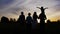 Three generation family walk in meadow at sunset