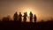 Three generation family walk in meadow at sunset