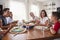 Three generation Hispanic family sitting at the table eating dinner