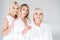 Three generation smiling blonde women isolated