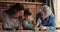 Three generation women family lying on floor drawing with brushes