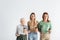 three generation of women holding coffee