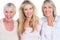 Three generations of cheerful women smiling at camera