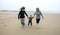 Three generations female running on the beach