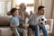 Three generations of men watch football match at home