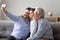 Three generations relatives men sitting on couch take selfie photo