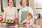 Three generations of women baking in kitchen